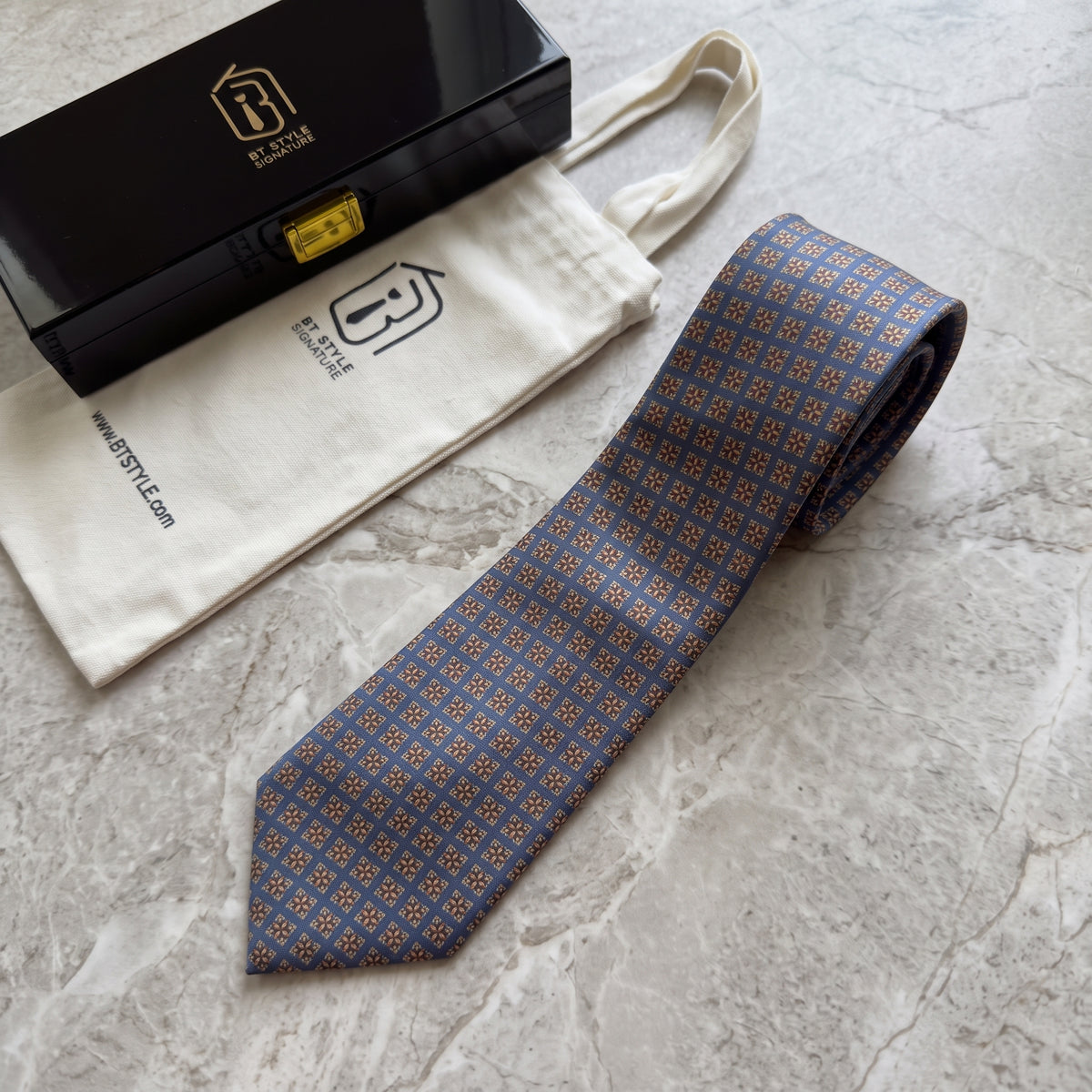 Windsor slate-blue tie with BT Style Signature gift box and fabric pouch on marble