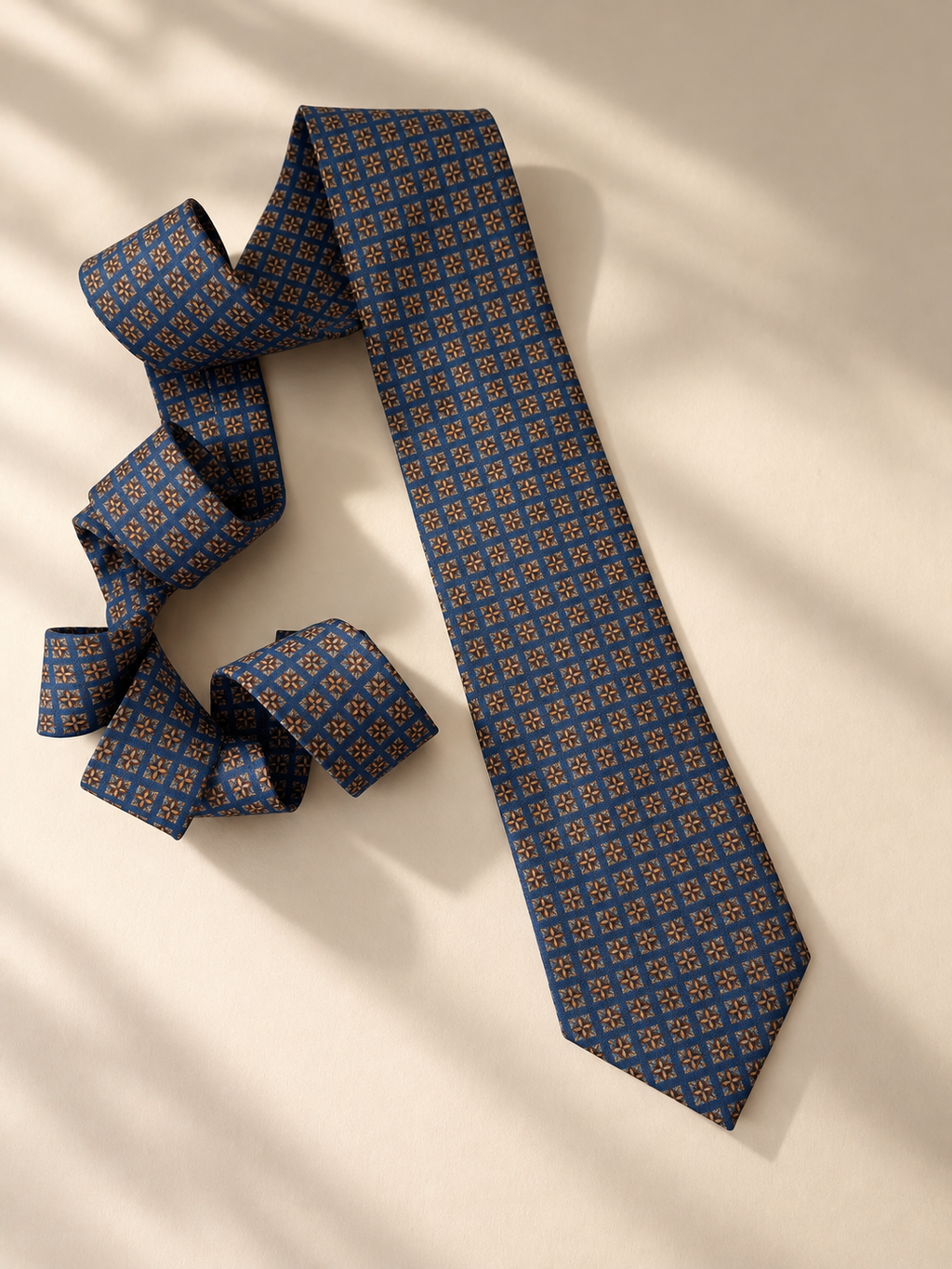 Windsor slate-blue necktie laid flat in soft window light