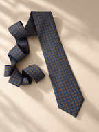 Windsor slate-blue necktie laid flat in soft window light