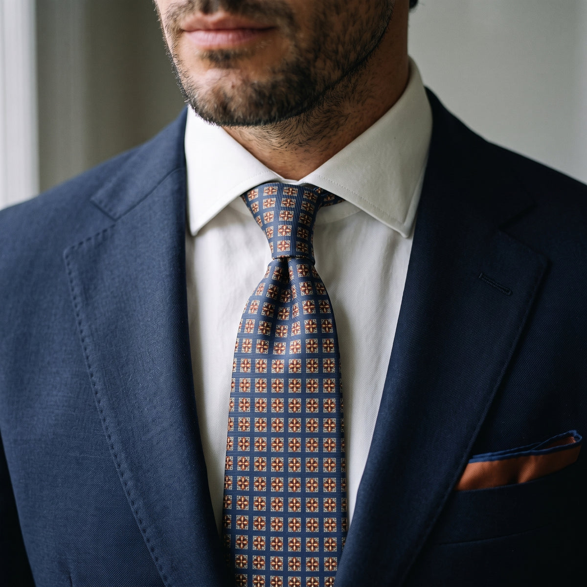 Close-up of the Windsor tie worn with a navy suit, white shirt and pocket square